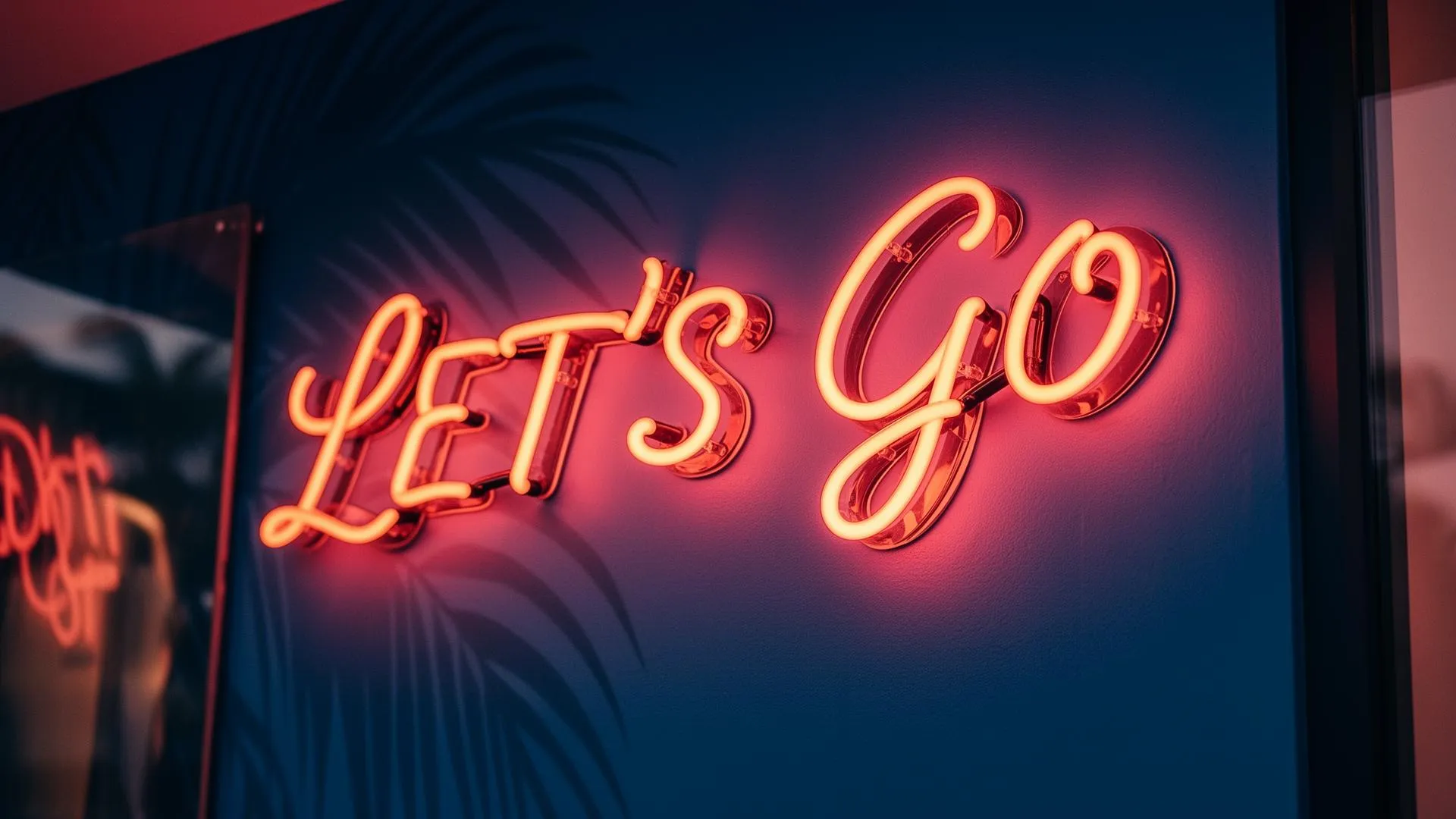 Coral neon sign reading LET'S GO at a Brimstreet hat bar event