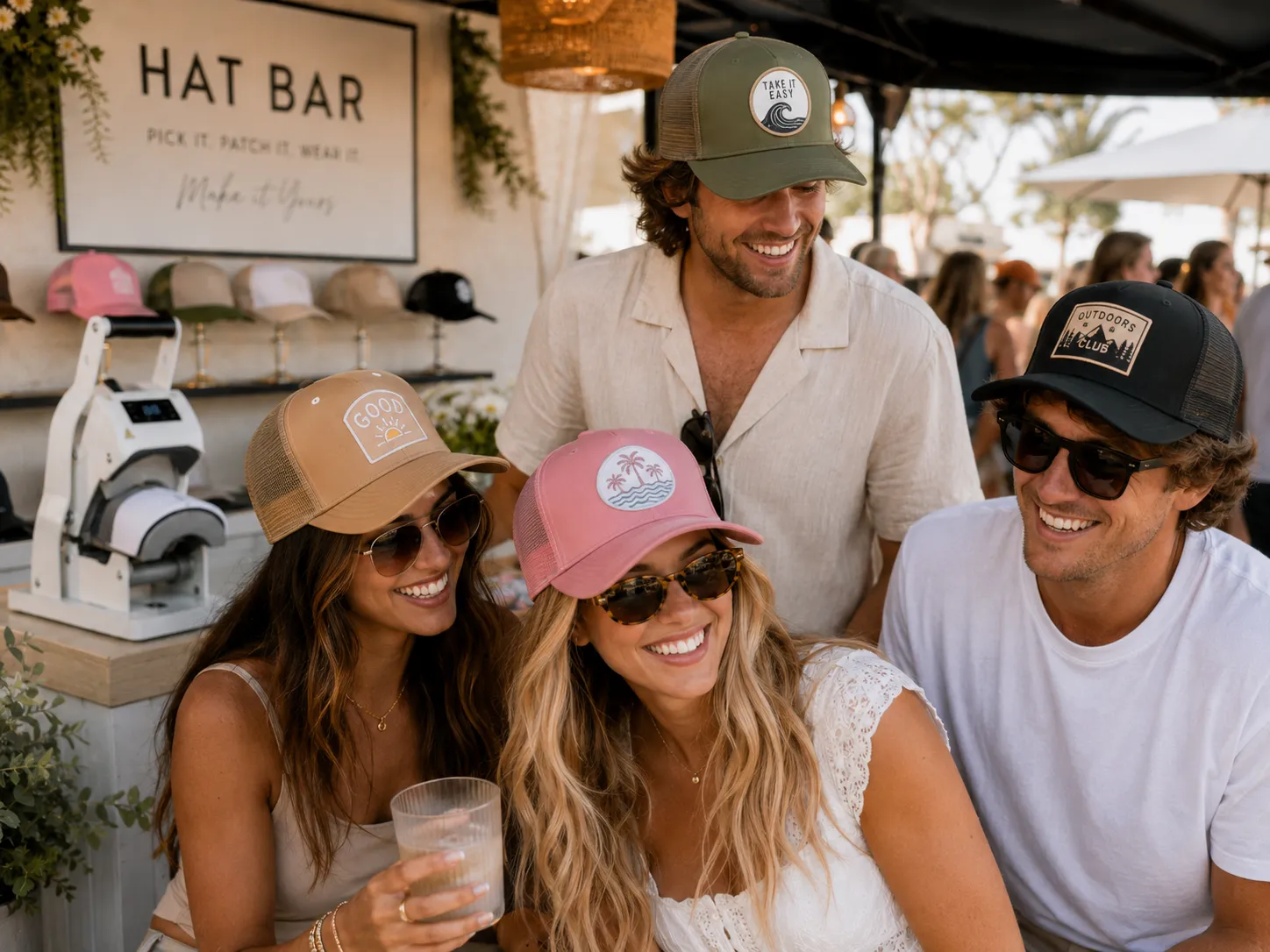 Four friends laughing in their finished custom trucker hats at a Brimstreet hat bar event